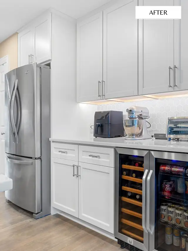 White shaker cabinets with built-in beverage fridge, white counters and stainless refrigerator