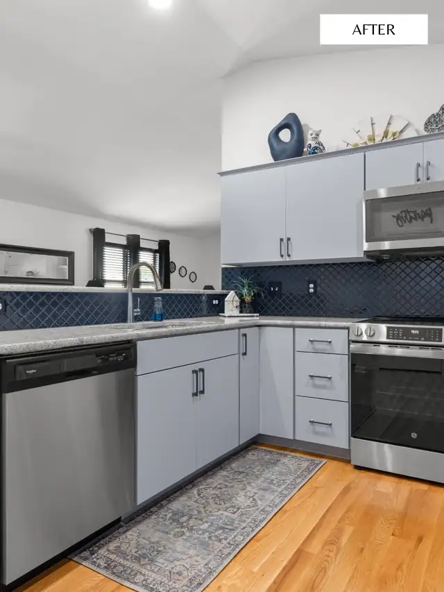 Refaced kitchen cabinets in light gray shaker style with navy arabesque tile backsplash and stainless appliances