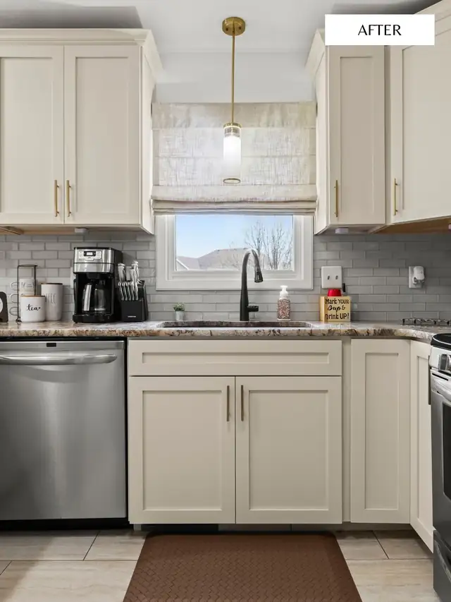 Cream shaker cabinets with granite counters, gray subway tile and brass pendant over the sink